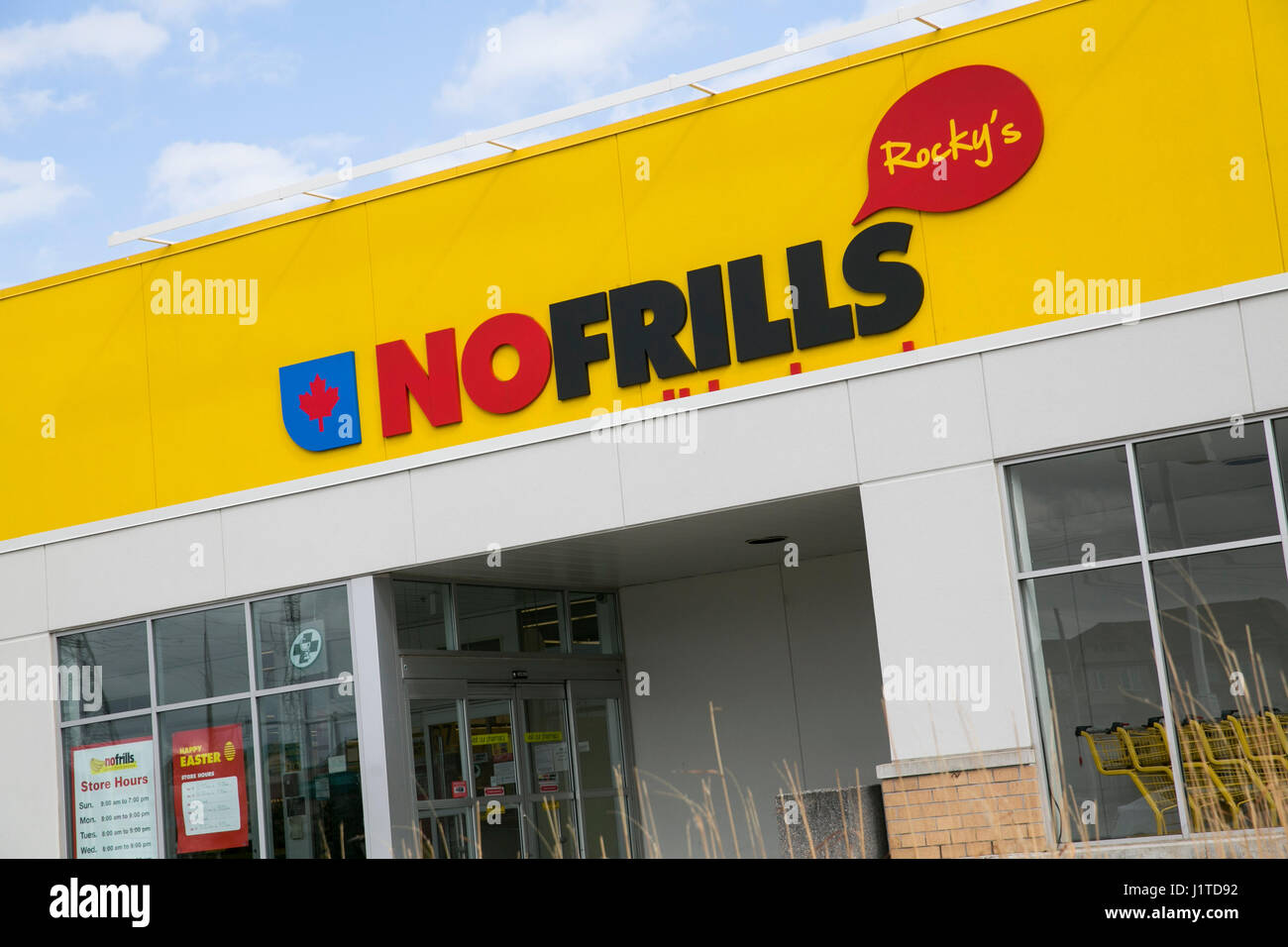 A logo sign outside of a No Frills grocery retail store in Mississauga
