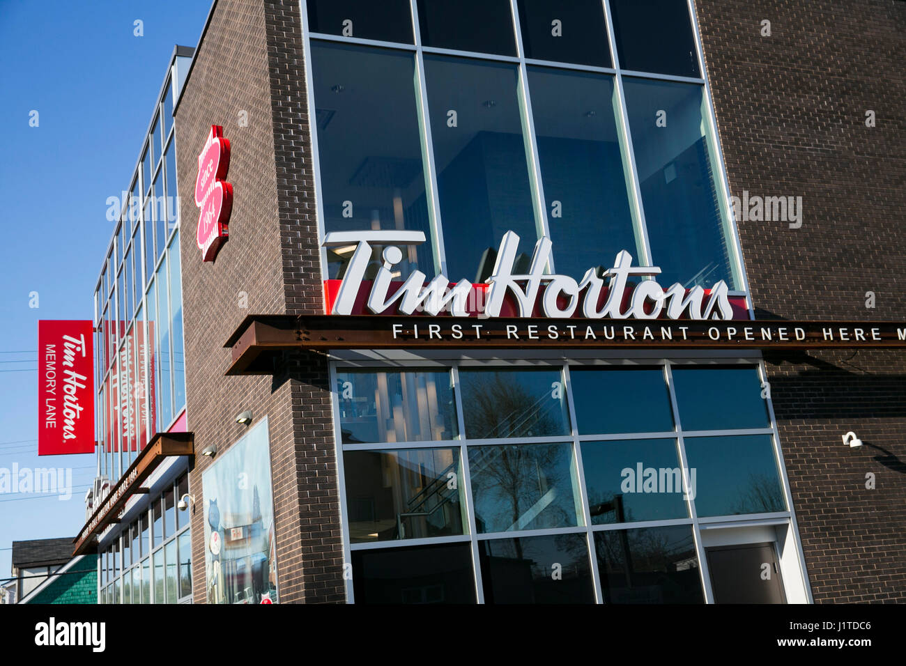 A logo sign outside of the location of the first Tim Hortons restaurant in Hamilton, Ontario, Canada, on April 17, 2017. Stock Photo