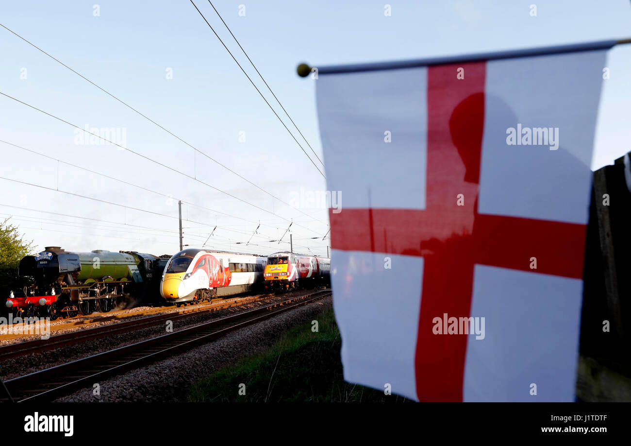 (left to right) The Flying Scotsman and Virgin Trains' new Azuma travel in the same direction alongside two of the rail operator's present day fleet - to depict the past, present and future of UK rail travel, in a world first event, in the North Yorkshire countryside. Stock Photo