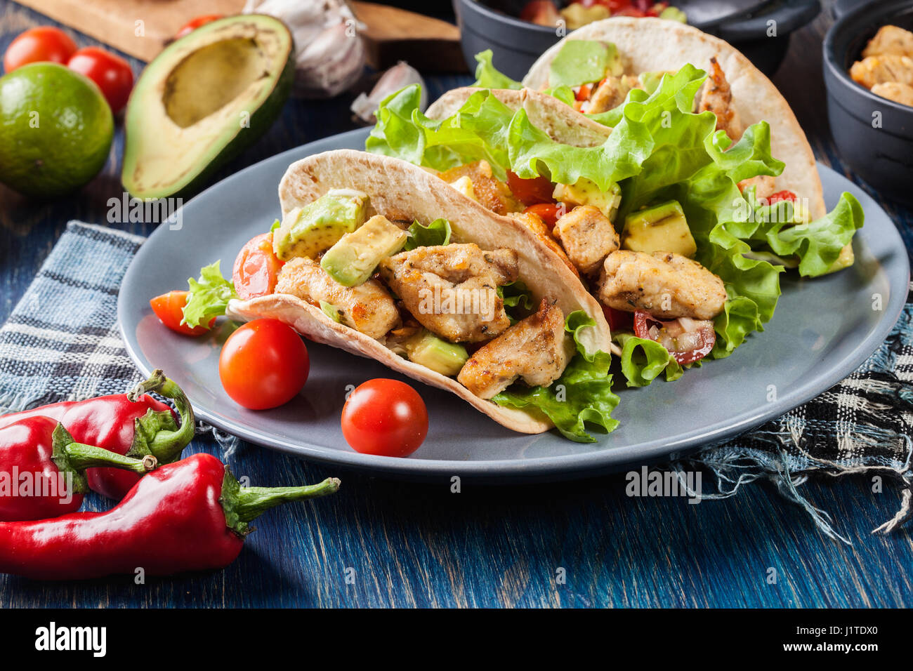 Authentic mexican tacos with chicken and salsa with avocado, tomatoes and chillies. Mexican