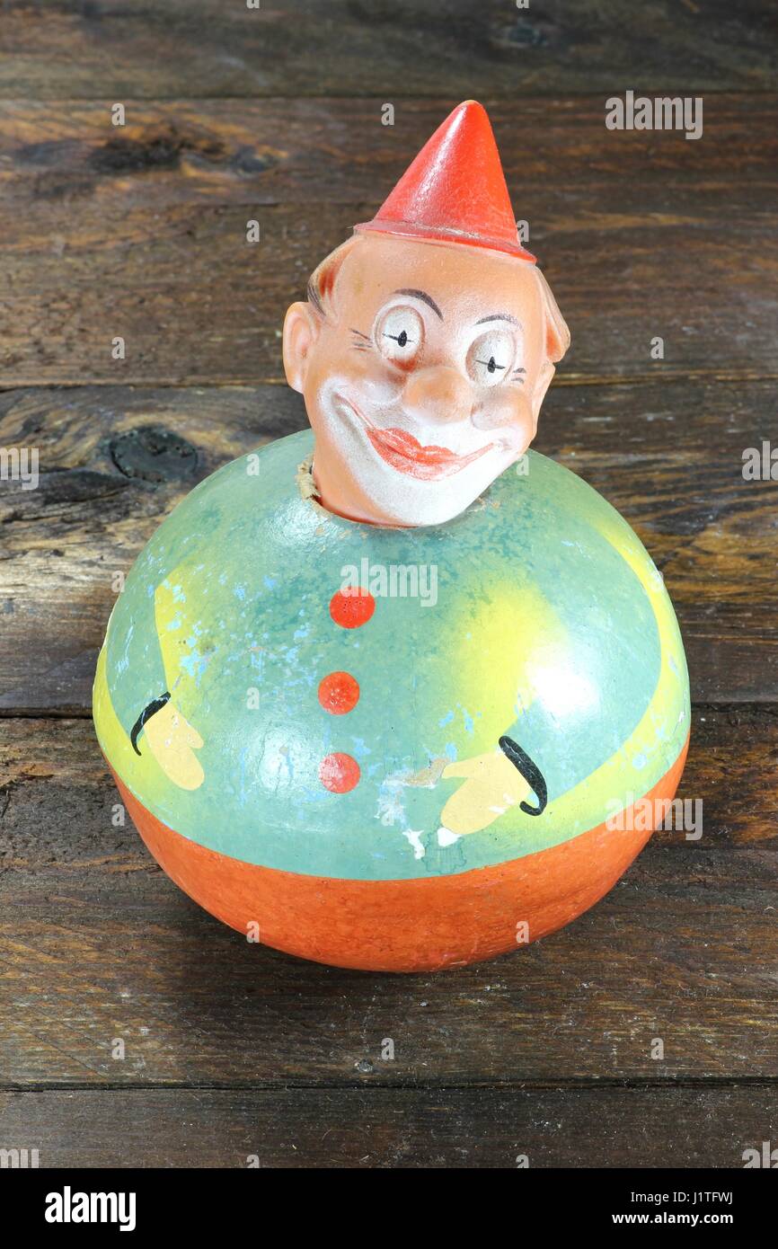 antique roly-poly doll on wooden background Stock Photo
