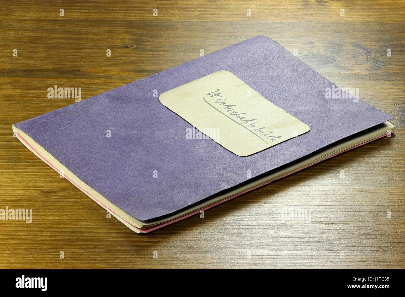 old German housekeeping book on wooden background Stock Photo