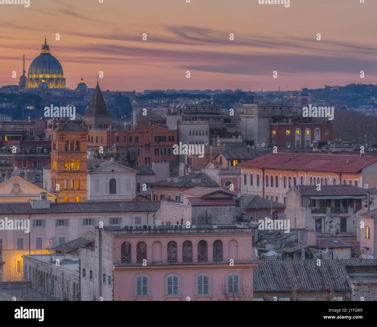 Basilica di San Pietro and the rooftops of Trastevere taken from the Giardino degli Aranci at sunset Stock Photo