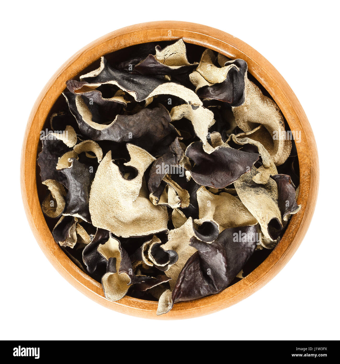 Dried black fungus in wooden bowl. Auricularia auricula-judae, also known as Jew's, wood or jelly ear, or Mu Err. Ingredient in Chinese dishes. Stock Photo