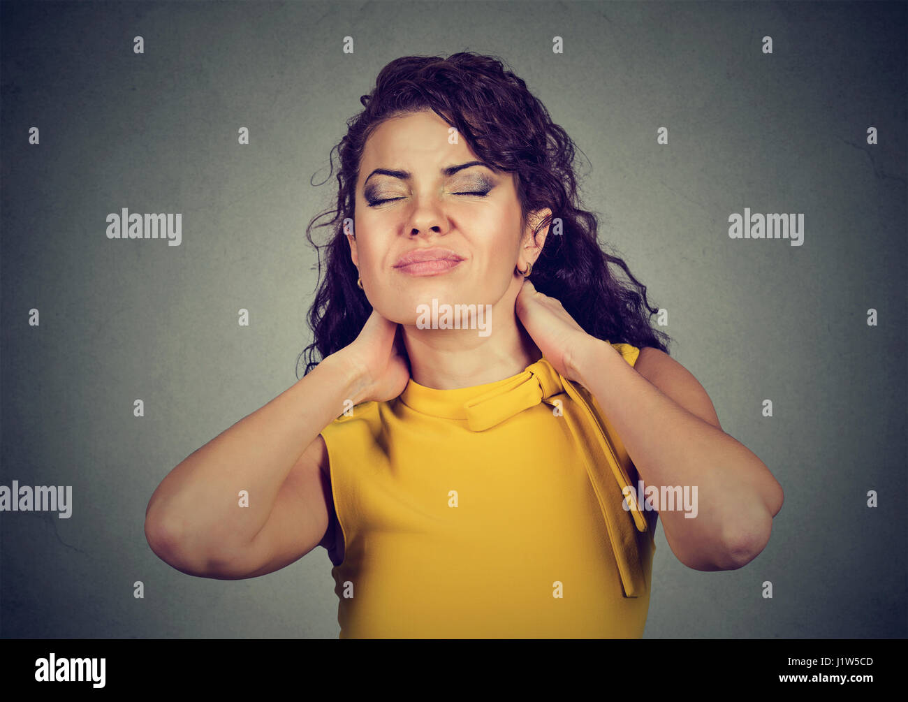 Young woman with neck pain Stock Photo