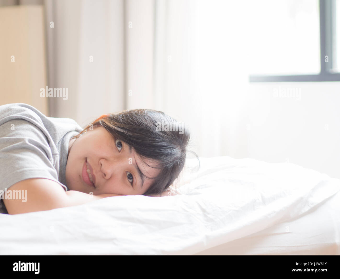 Chinese Woman Lying on Bed Stock Photo Alamy