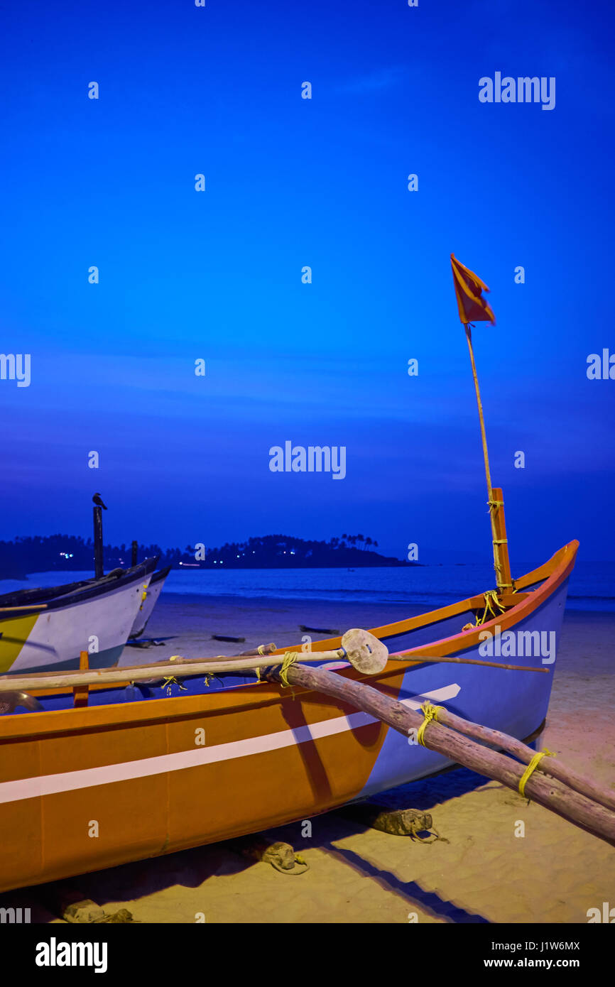 Traditional longtail boat at sunset on tropical island Stock Photo - Alamy