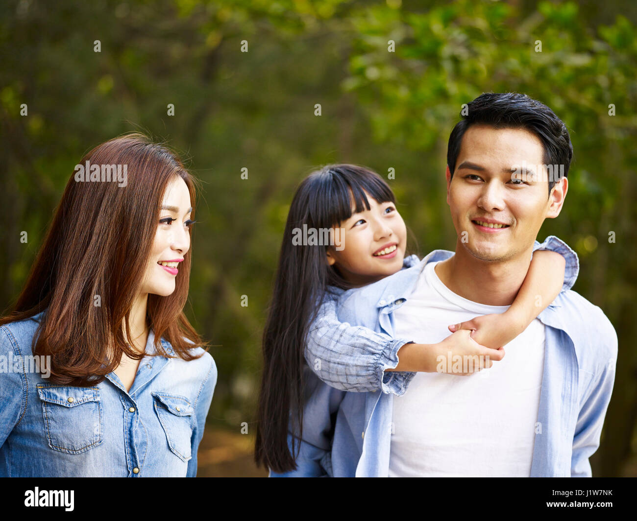 young asian family walking enjoying nature. Stock Photo