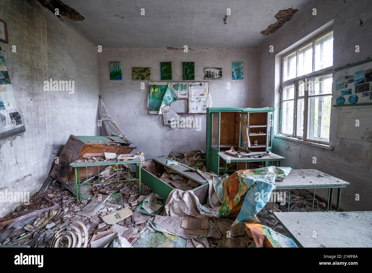 Geography classroom in old secondary school in Mashevo abandoned village of Chernobyl Nuclear Power Plant Zone of Alienation in Ukraine Stock Photo