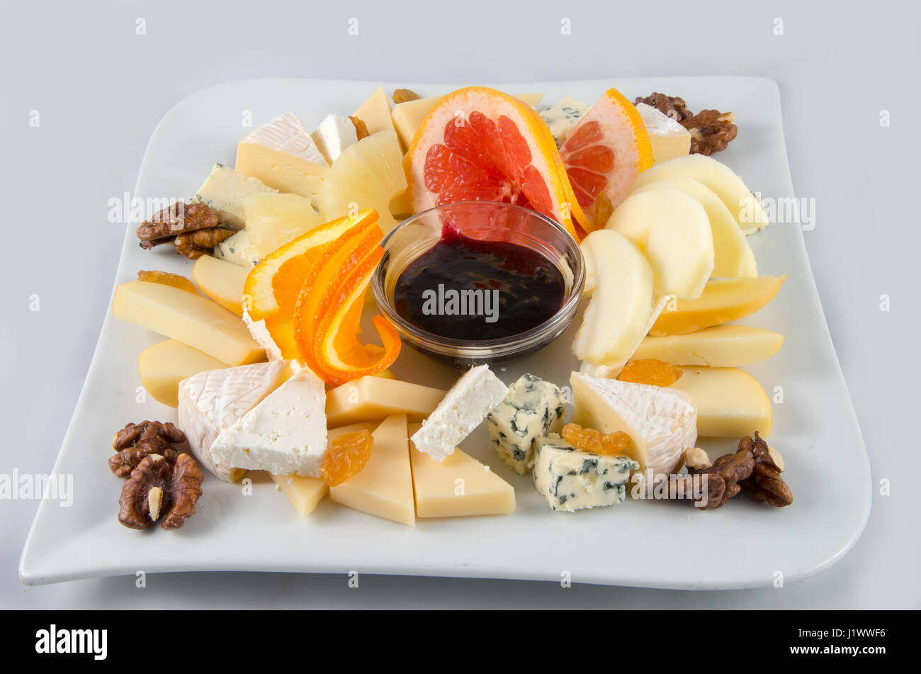 Fruit salad with nuts, raisins and cheese. Stock Photo