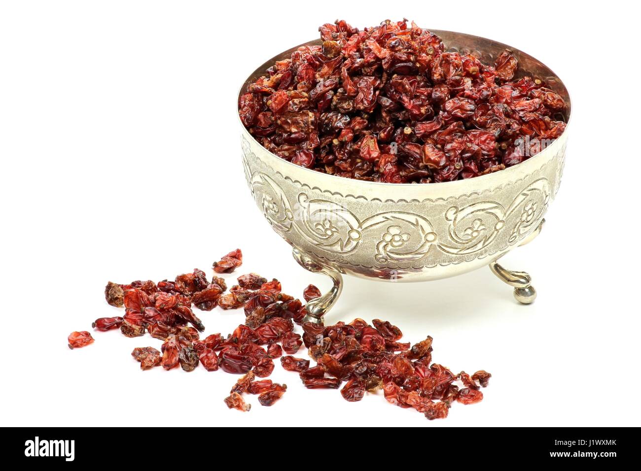 dried berberis in a silver bowl isolated on white background Stock Photo