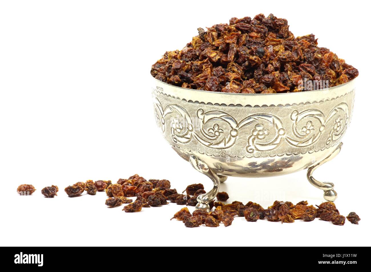 dried sea buckthorn berries in a silver bowl isolated on white