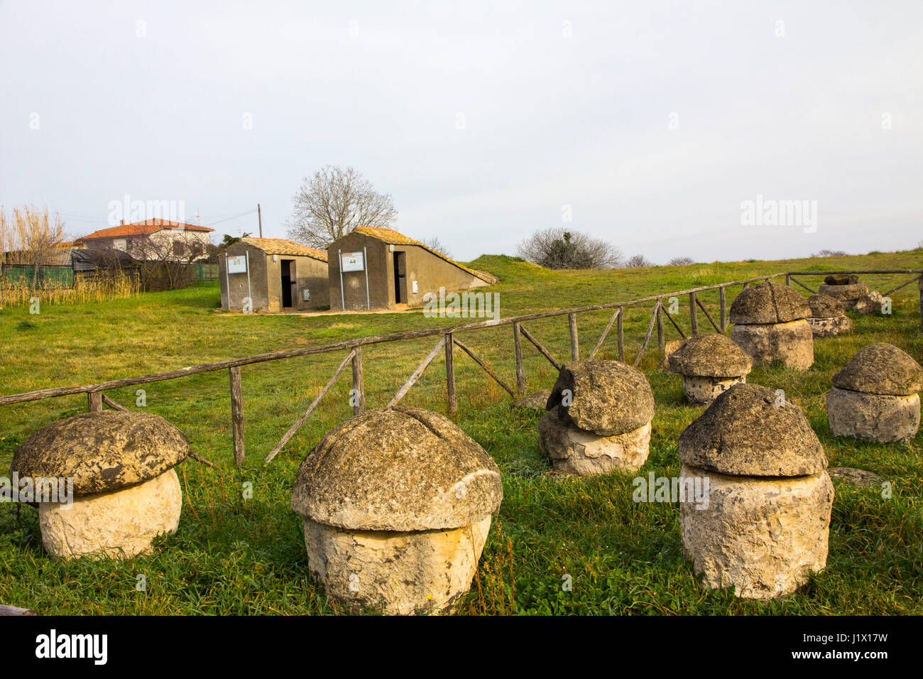Simple round tombs carved from rock for cremation burials during the Villanovan period around the 9th Century BC can be seen at Monterozzi Necropolis  Stock Photo