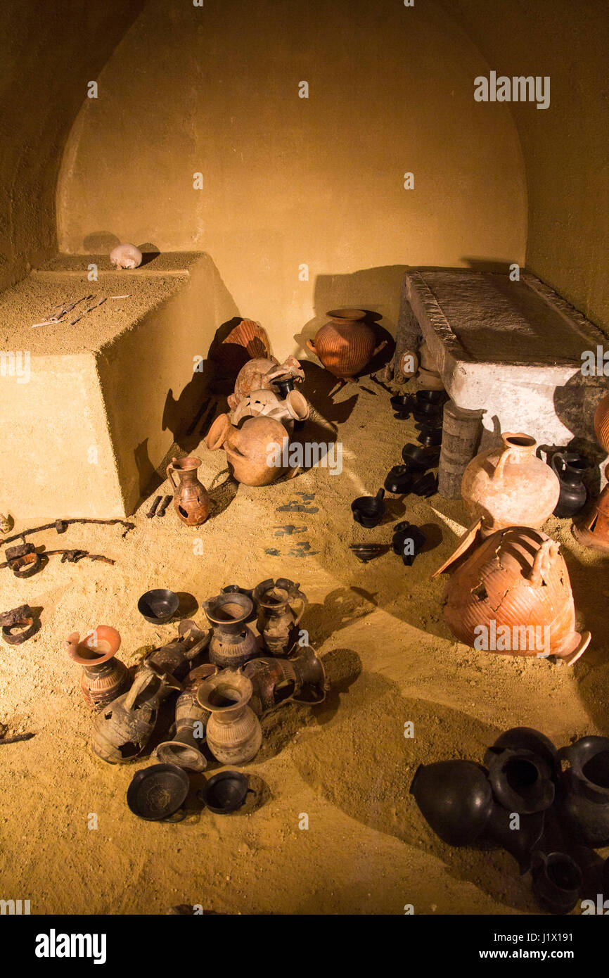 This exhibit illustrates how an undisturbed Estruscan tomb might have appeared.  It adjoins the entrance to the National Archaeological Museum of Tarq Stock Photo