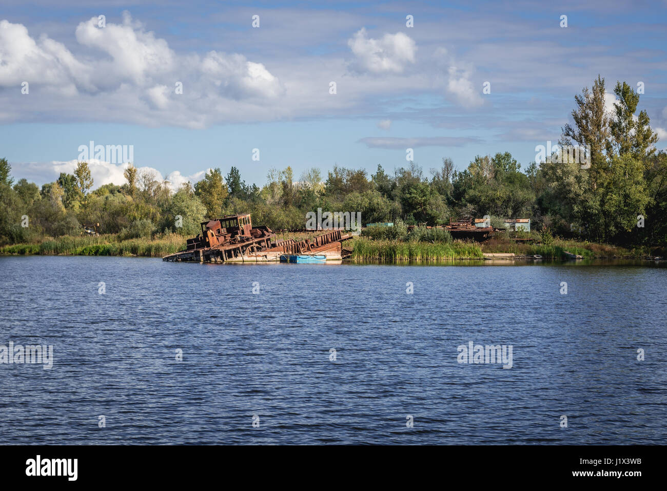 Ship wrecks around bank of backwater of Pripyat River in Chernobyl town, Chernobyl Nuclear Power Plant Zone of Alienation, Ukraine Stock Photo