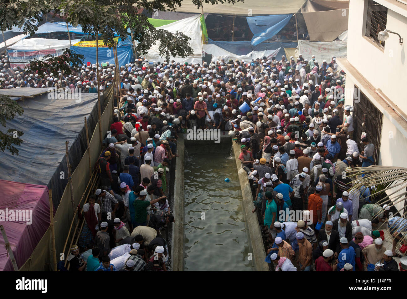 Devotees wash themselves before offering Jumma prayers on the first day of Bishwa Ijtema, the second largest religious congregation of Muslims in the  Stock Photo
