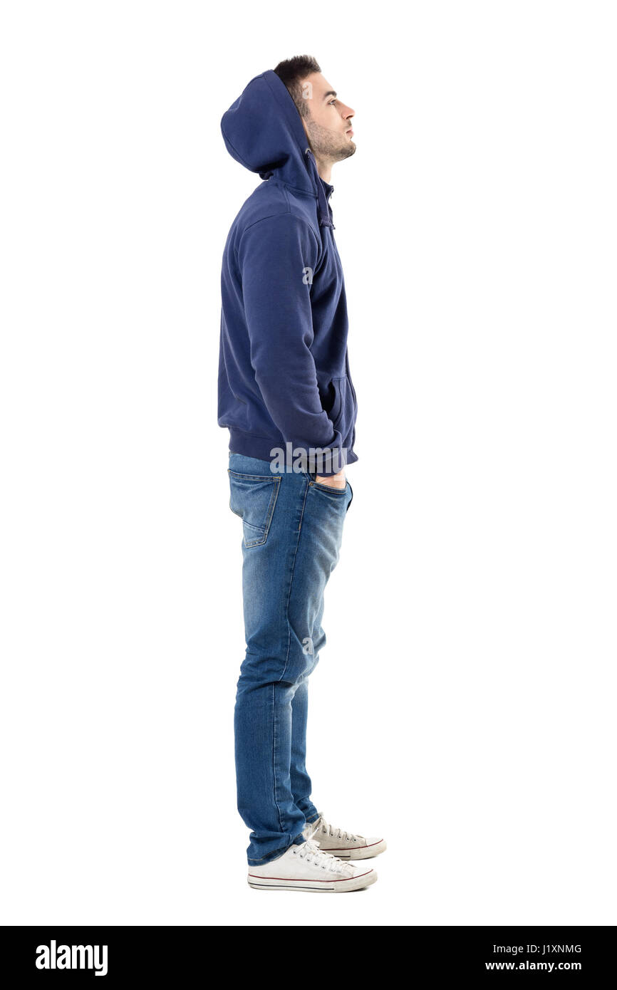 Vertical shot of thoughtful teenager dressed in stylish hoodie and