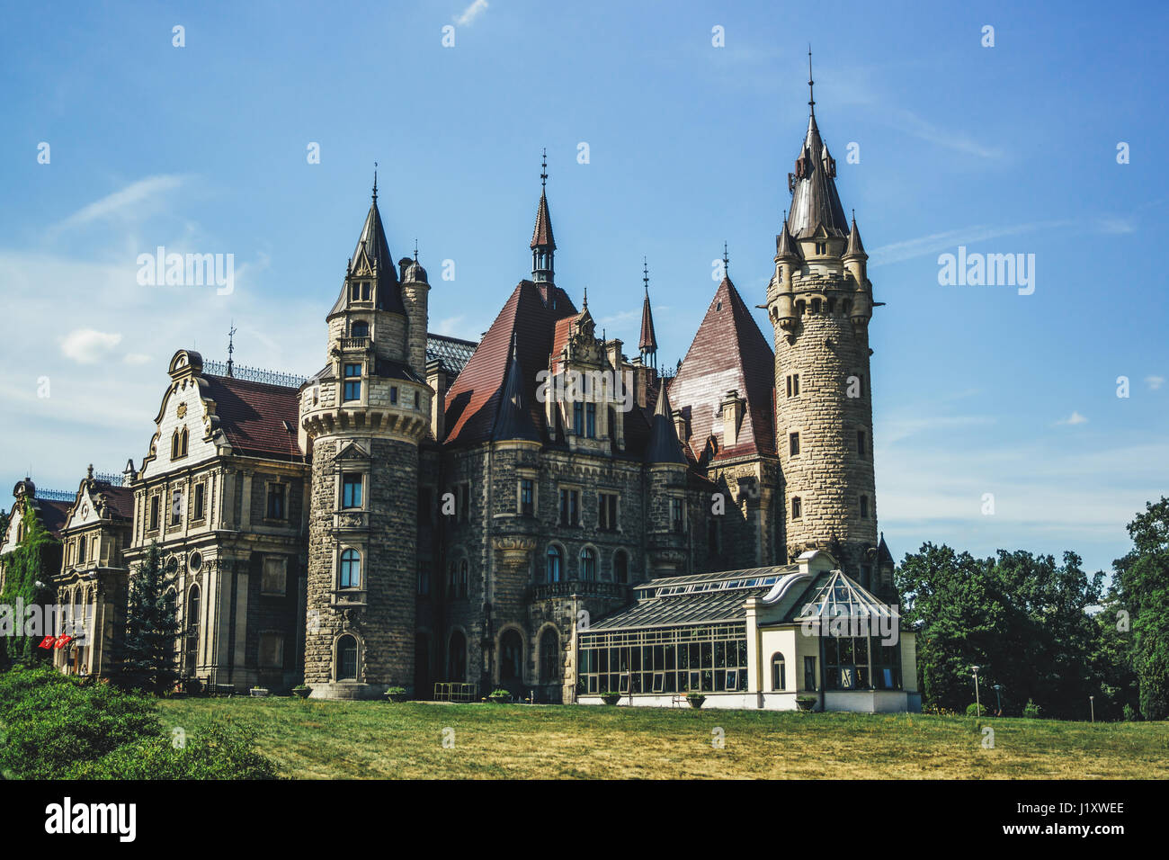 Moszna castle in Poland during the summer, side view of the palace with many towers. Stock Photo