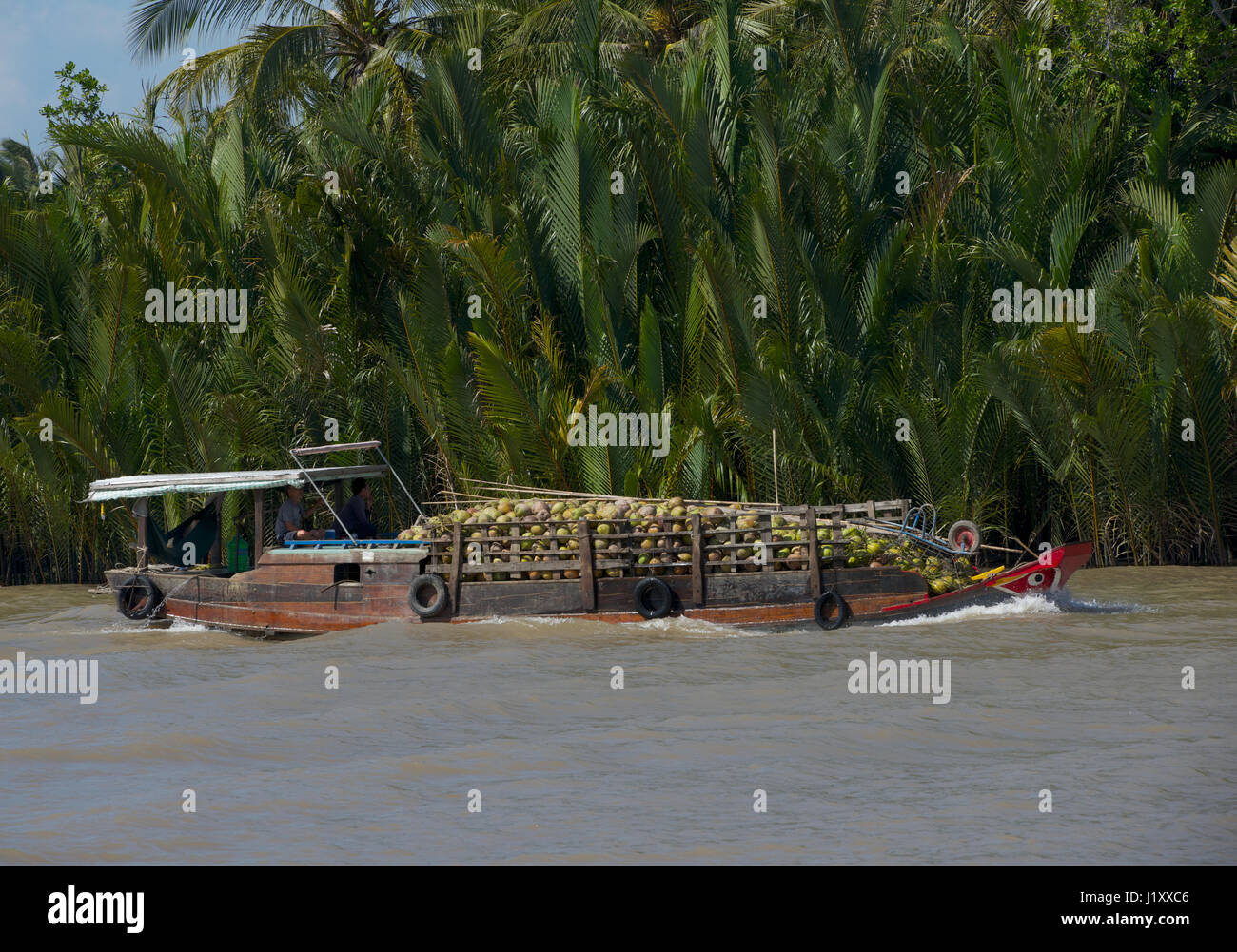 coconut boat on Saigon River Vietnam Stock Photo