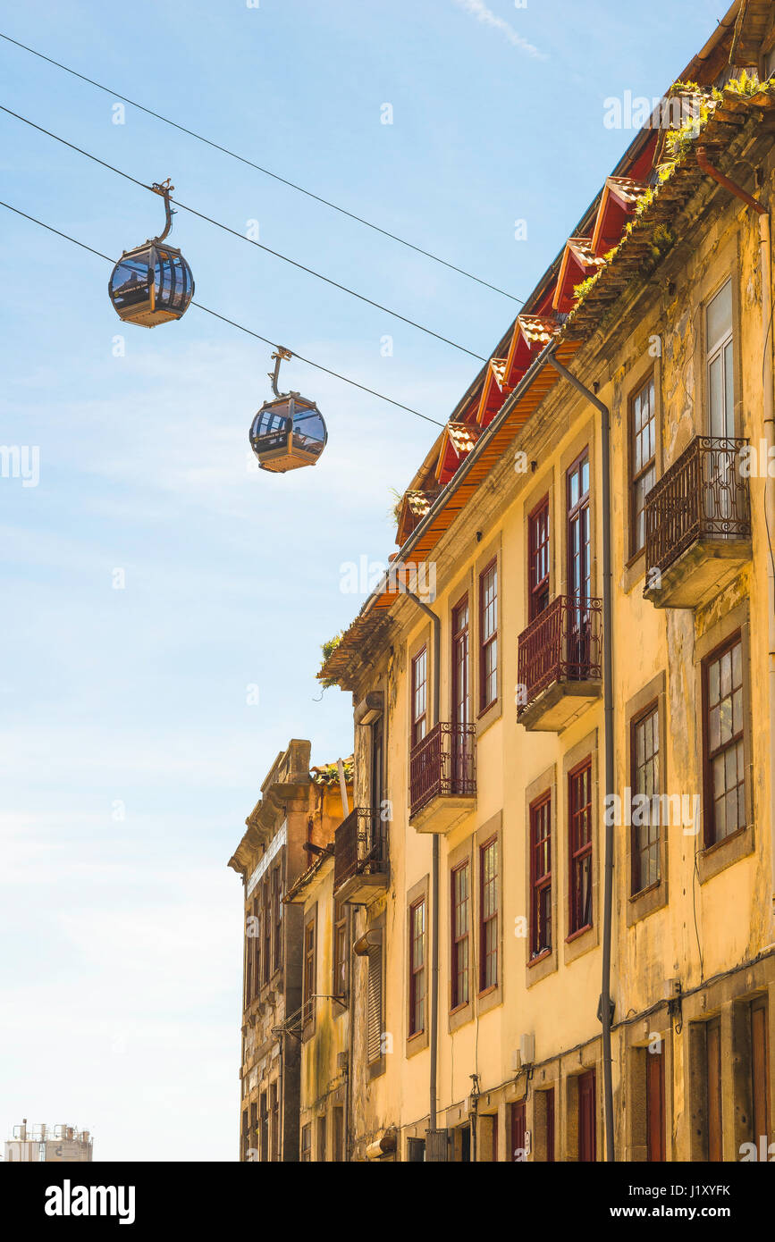 Porto Portugal Gaia, a pair of cable cars carrying tourists pass high above the streets of the Gaia district in the city of Porto (Oporto), Portugal. Stock Photo
