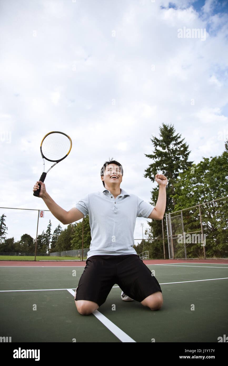 A happy asian male tennis player in joy after winning Stock Photo Alamy