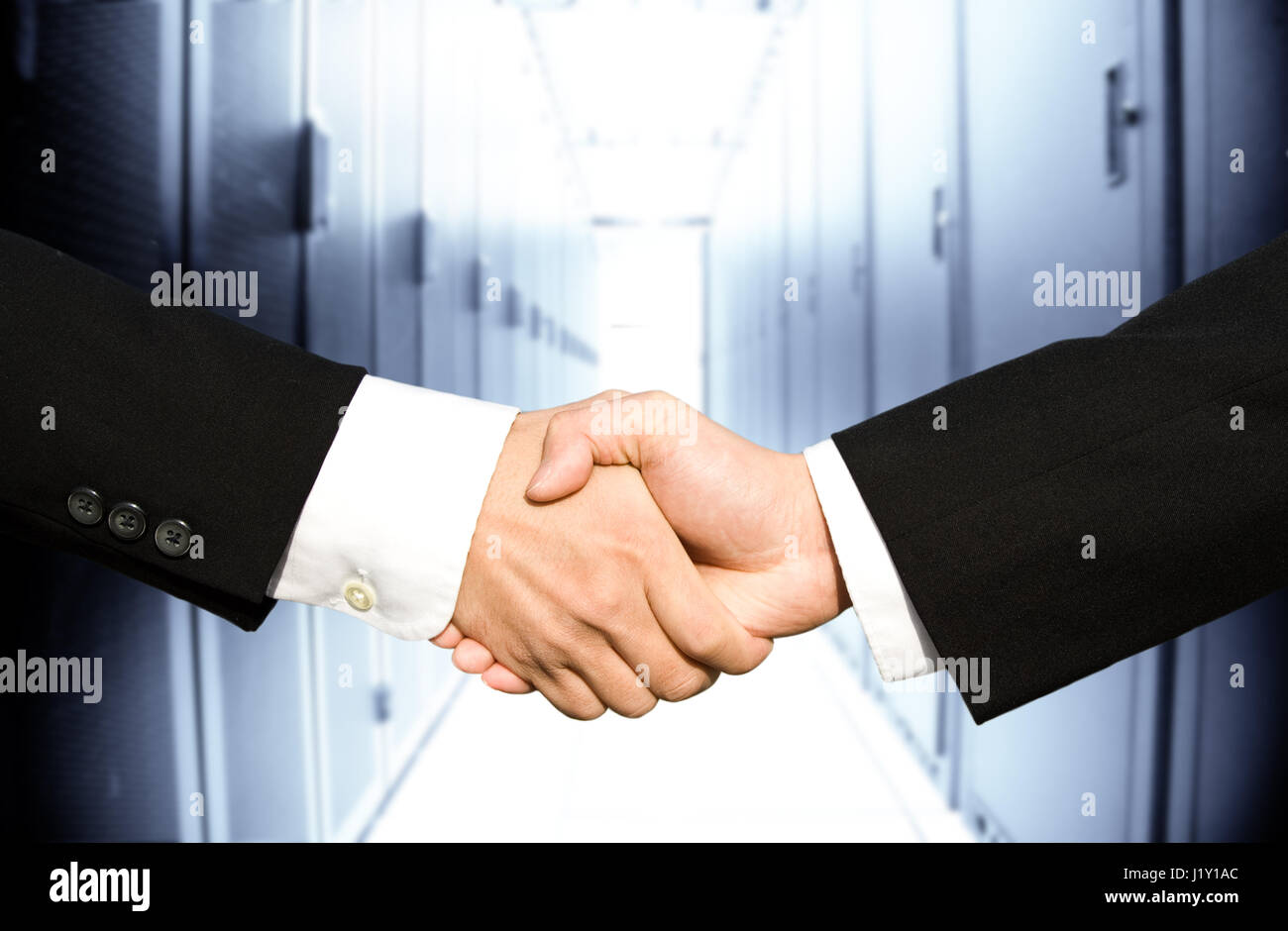Two businessmen shaking hands in a technology data center Stock Photo ...