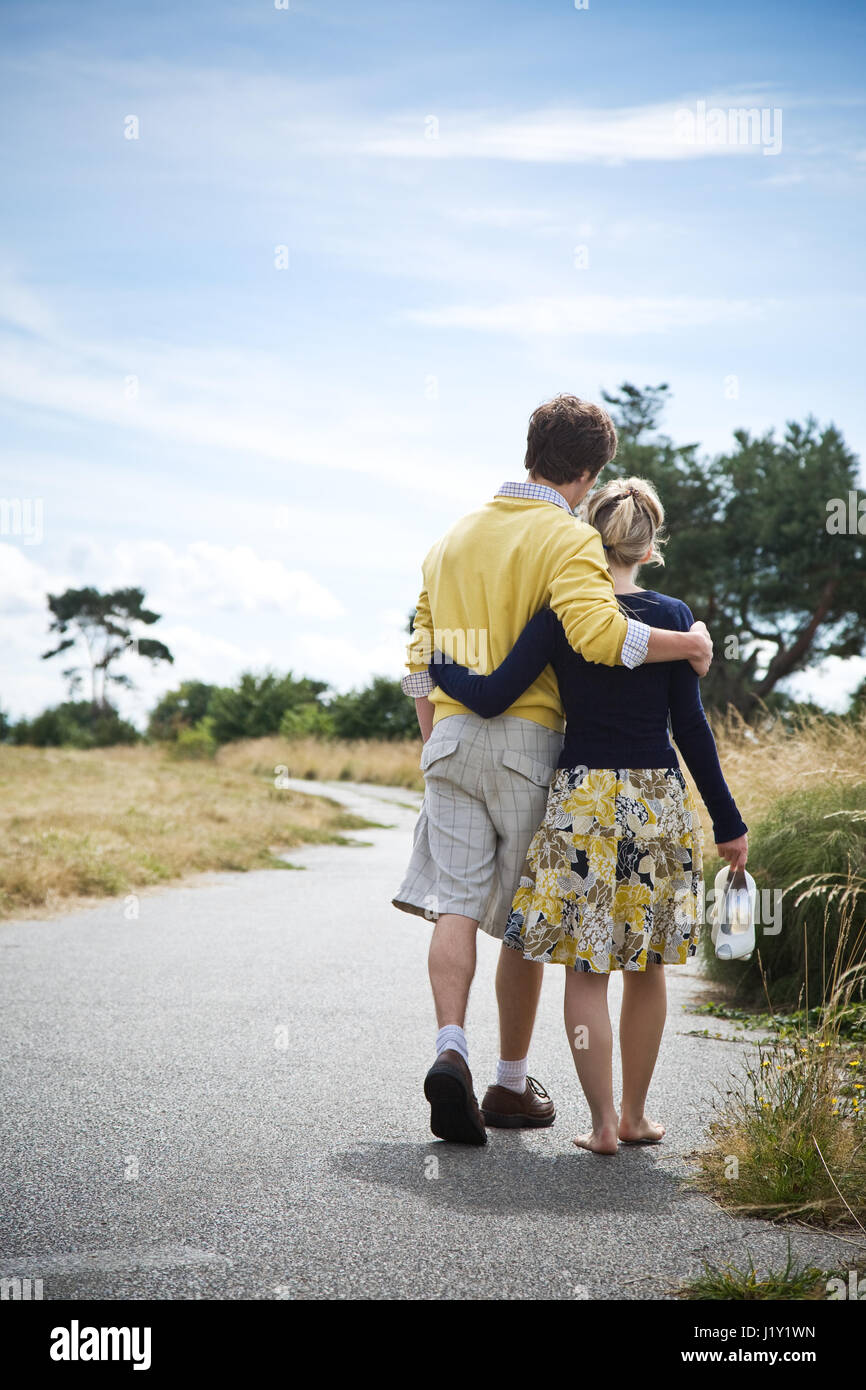 A young caucasian couple taking a walk in a park Stock Photo - Alamy