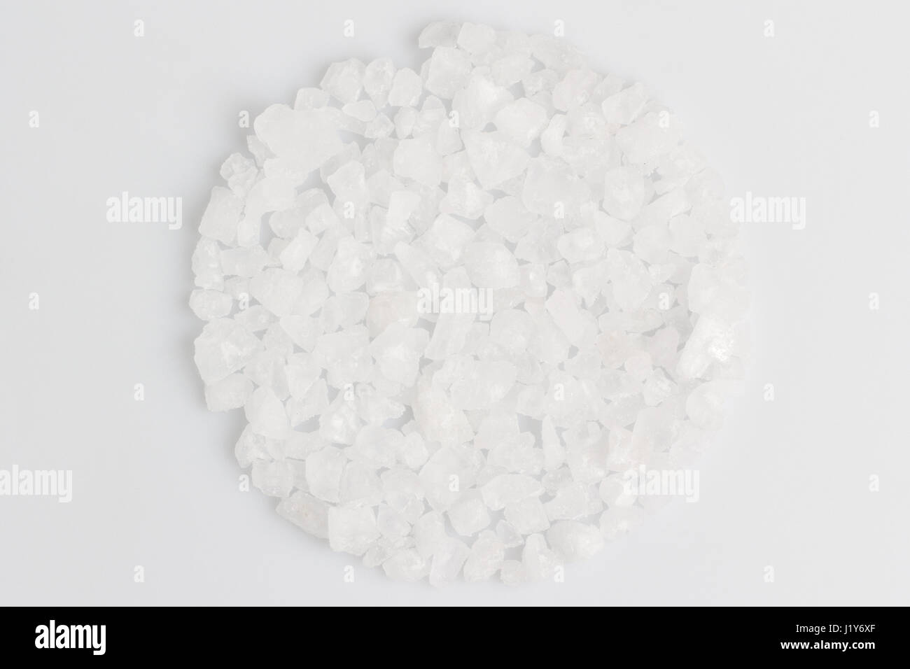 A scattering of sea salt on a white background Stock Photo - Alamy