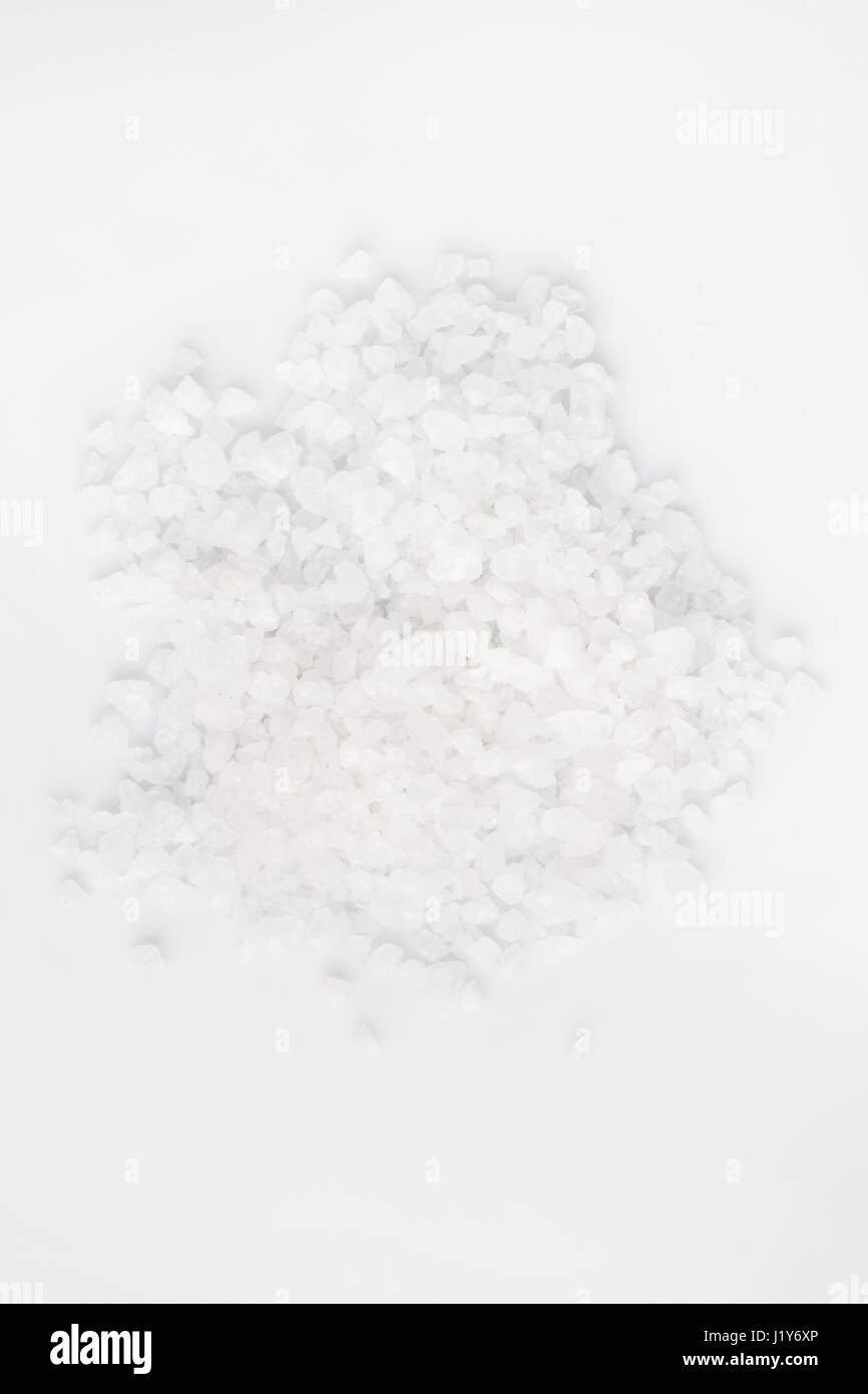 A scattering of sea salt on a white background Stock Photo - Alamy