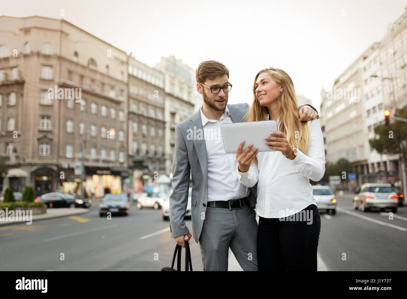 Business colleagues walking and talking on city streets Stock Photo - Alamy