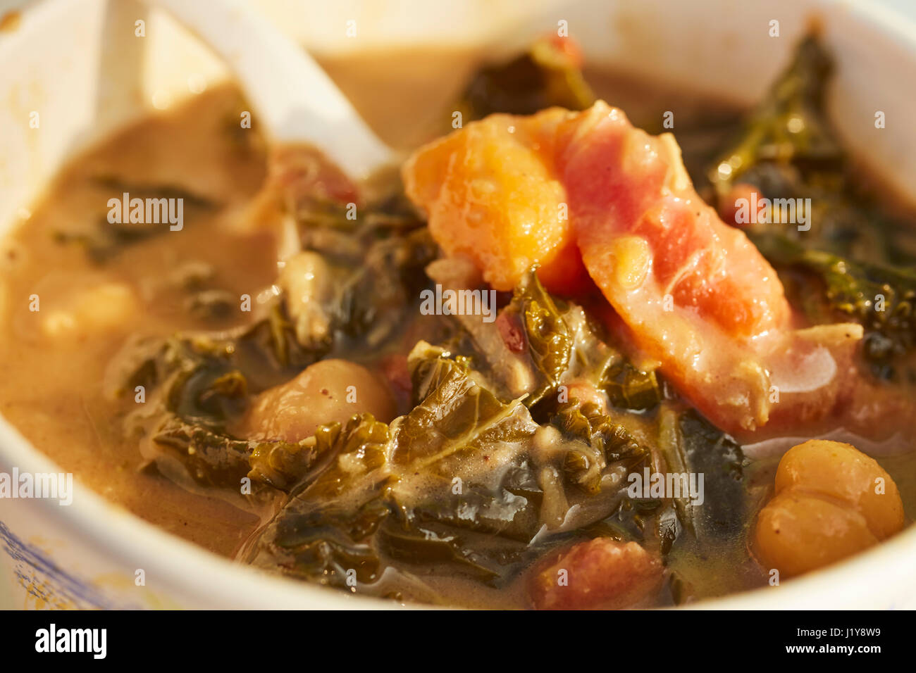 a cup of West African Peanut, Yam, and Collard Green soup sold by a Pennsylvania food truck