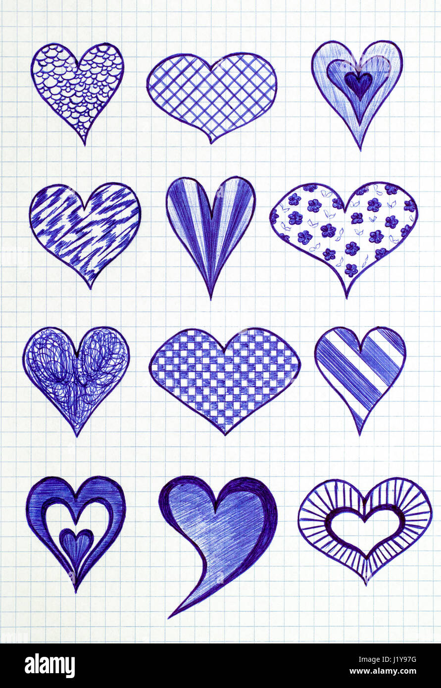 Twelve hand drawn heart shapes on the sheet of checkered paper. Doodle style. Stock Photo