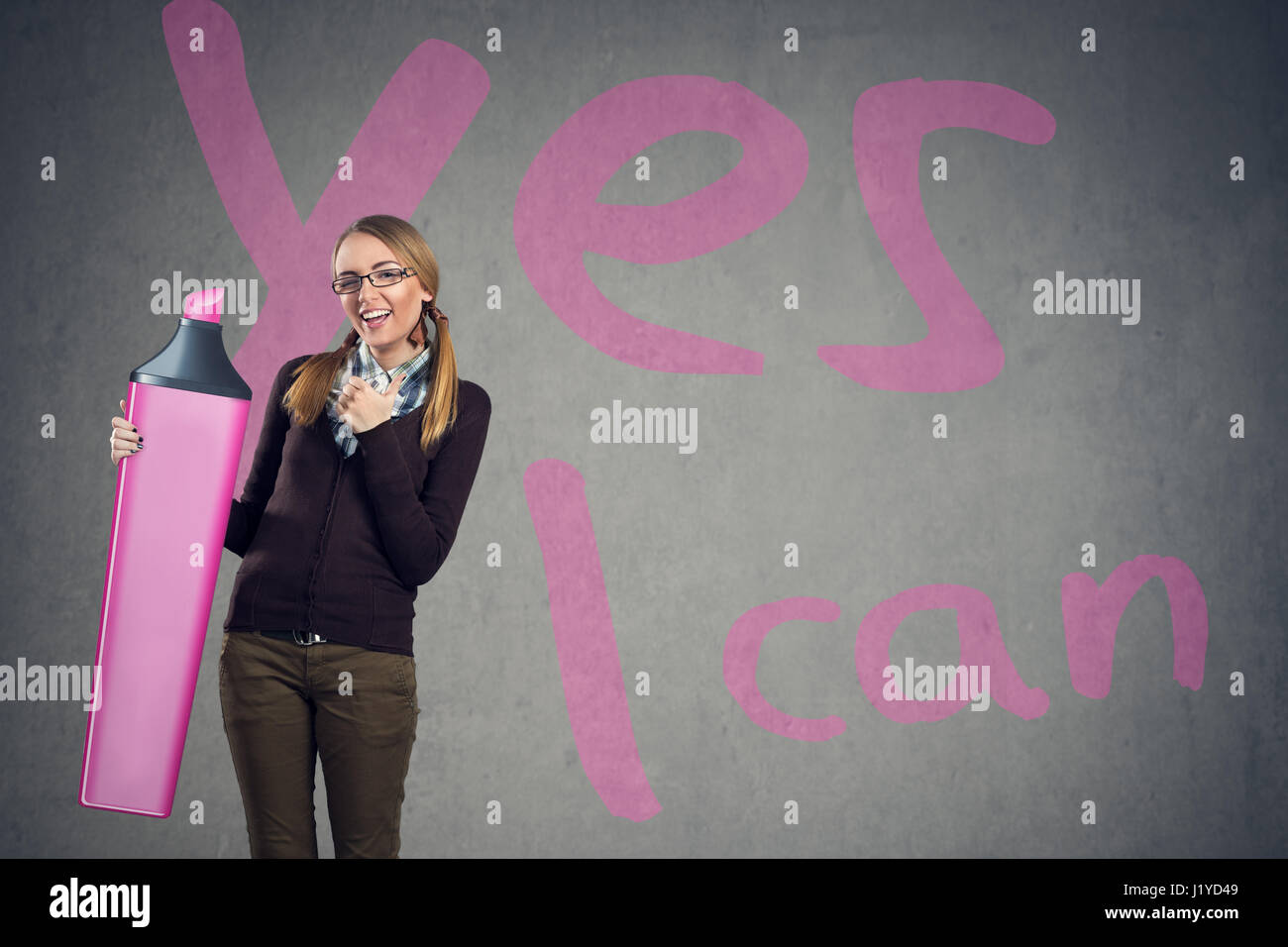 Cute girl believe in yourself with sing yes I can in background Stock Photo