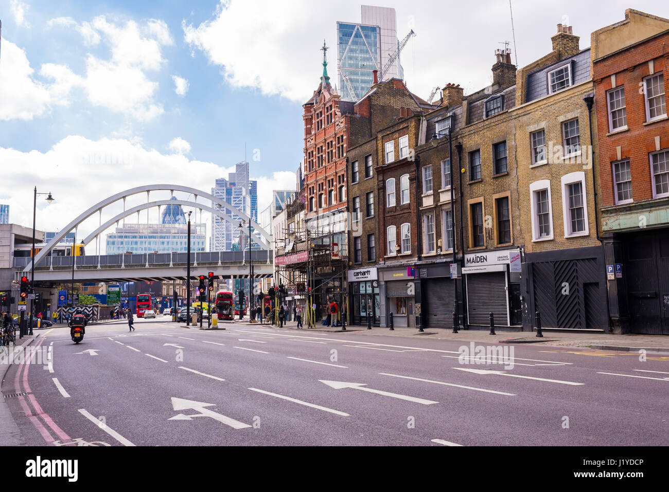 Shoreditch High Street with empty road, view of railway bridge and city in the background Stock Photo