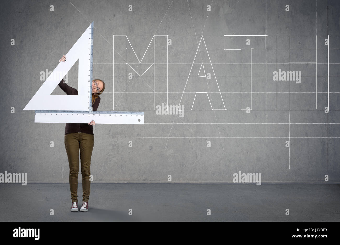 Funny schoolgirl with big ruler, mathematics concept Stock Photo - Alamy