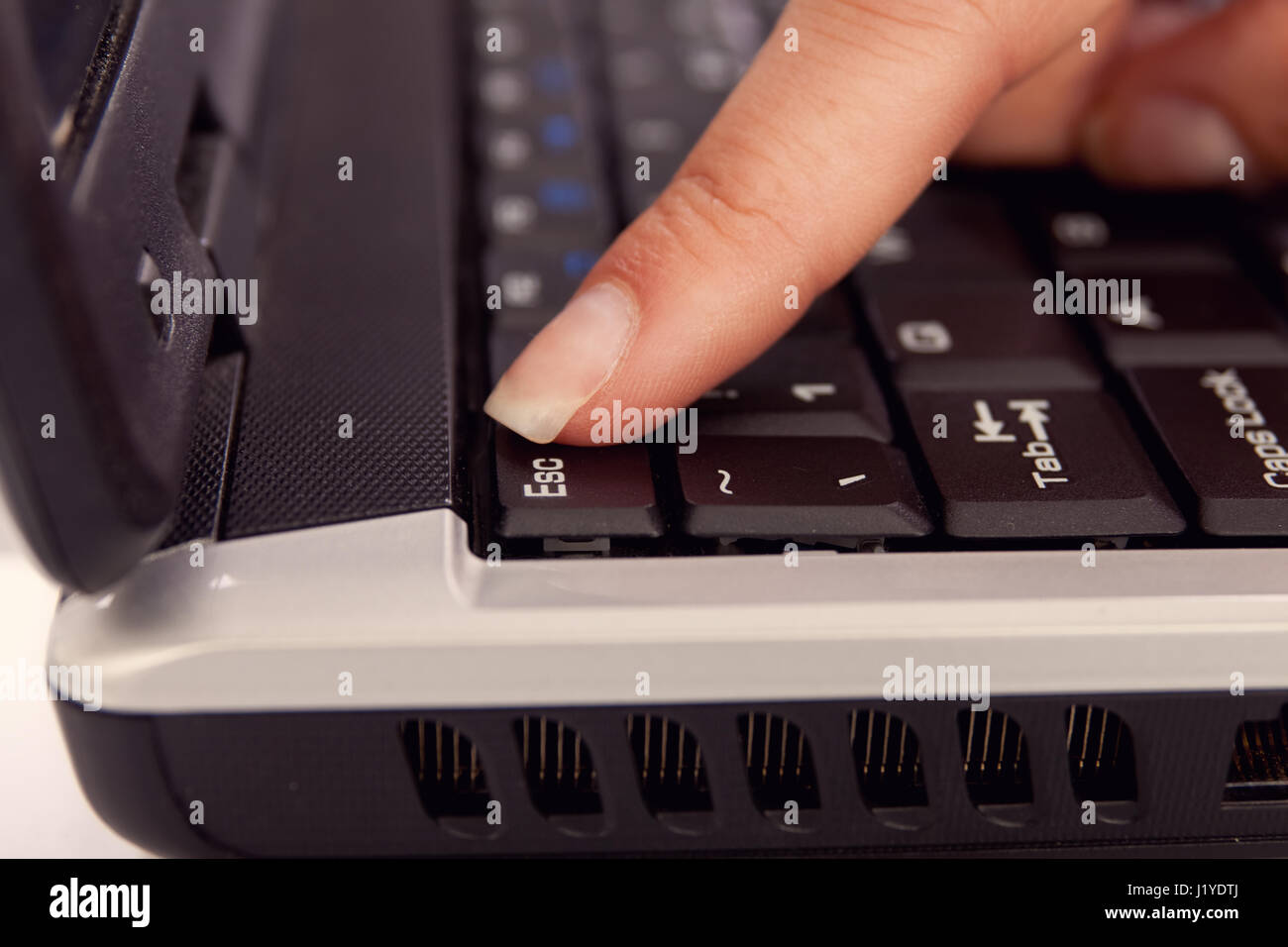 females finger pressing escape button on keyboard Stock Photo