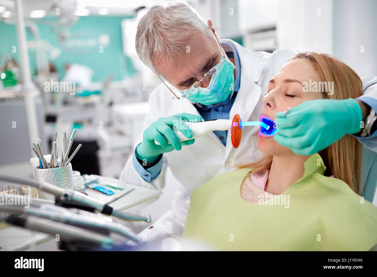Dentist use dental instrument with light in dental practice Stock Photo Alamy