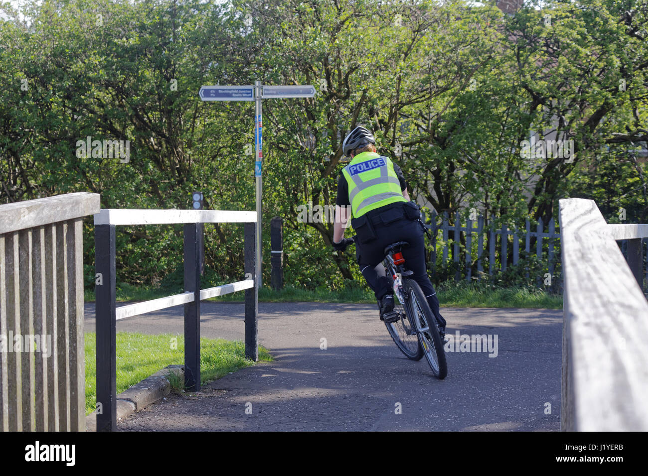 forth Clyde canal Scottish police man and woman on bicycle bike on the tow path Stock Photo