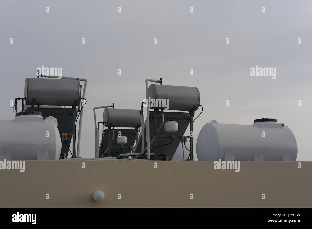 Roofmounted solar water heating units in Cyprus against a grey sky Stock Photo Alamy