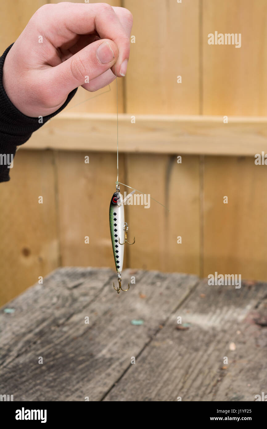 fishing lure freshly tied being held by line. Stock Photo