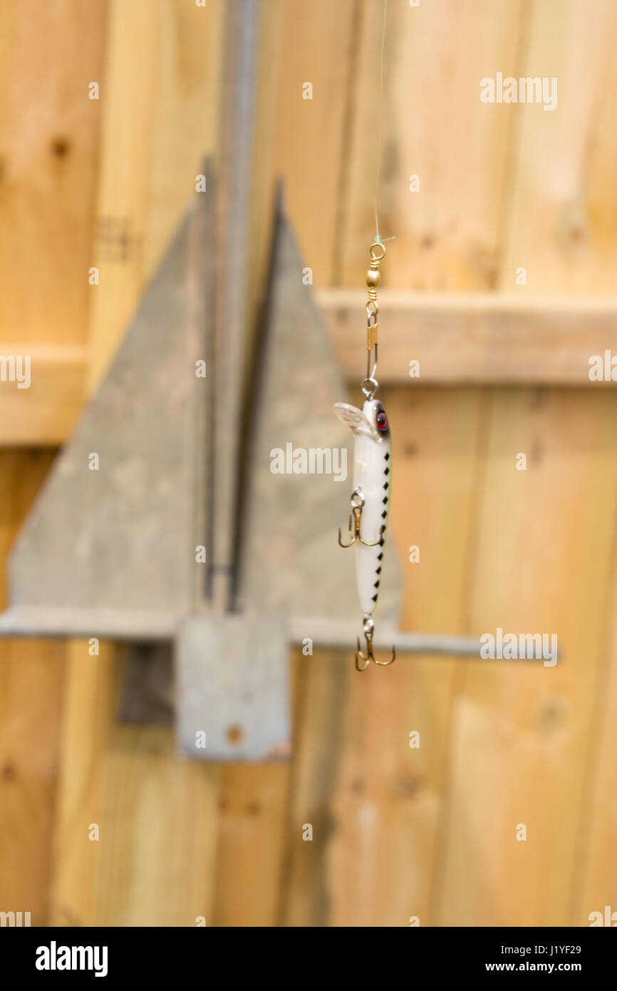 fishing lure freshly tied being held by line. Stock Photo