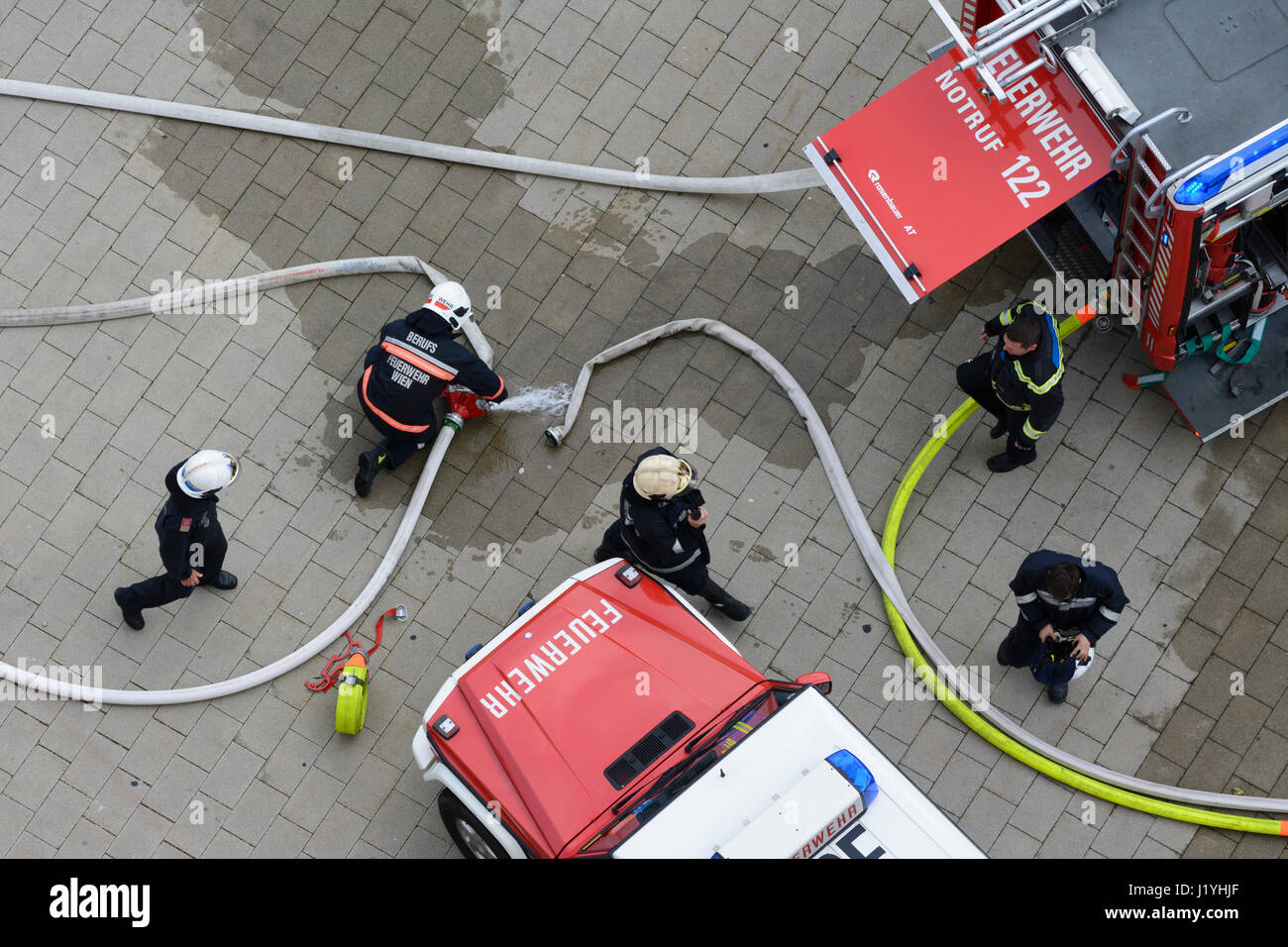 fire department trucks, firemen connecting hoses, Wien, Vienna, 22. Donaustadt, Wien, Austria Stock Photo
