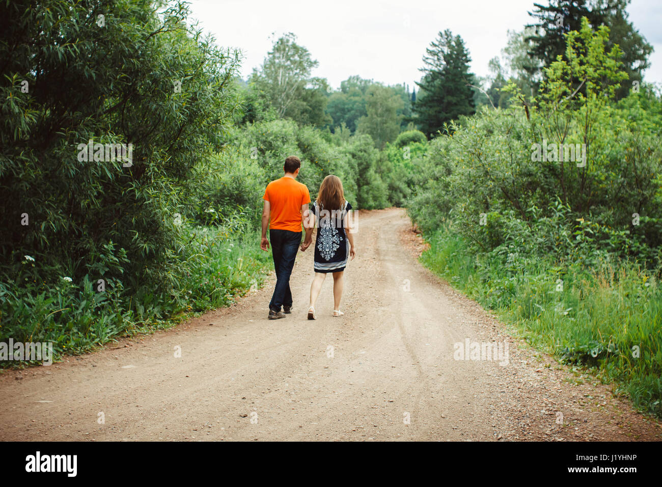 rear view of couple holding hands walking in autumn countryside Stock ...