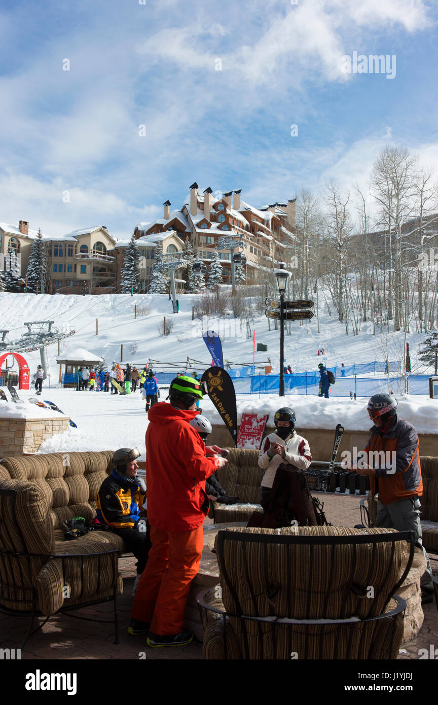 Skiers take a break and warm up around a fire at the Beaver Creek Resort. Stock Photo