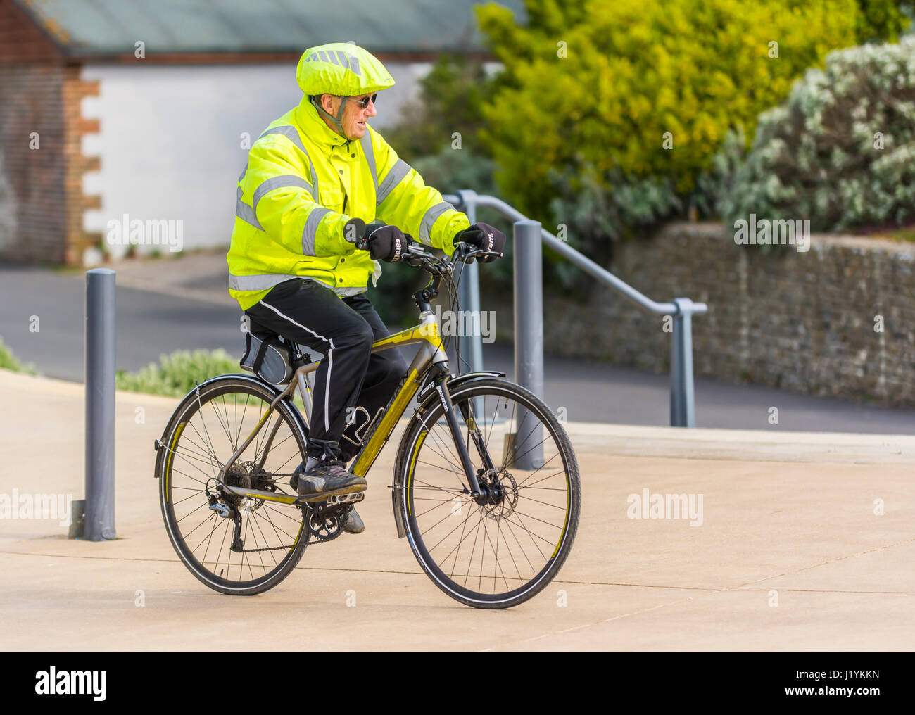 Elderly mam riding a bicycle. Senior cyclist. Stock Photo