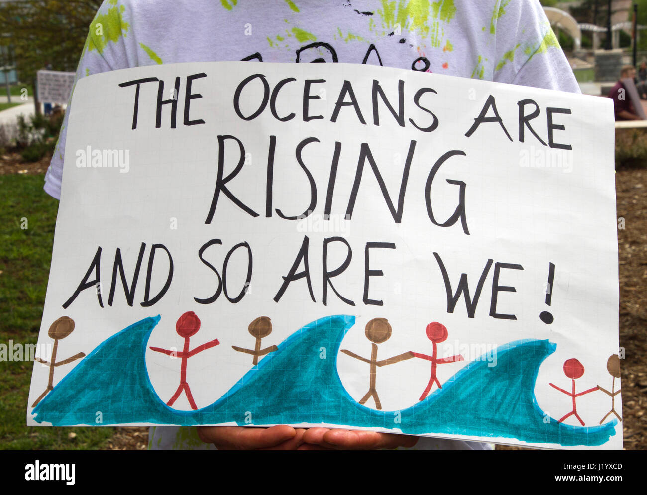 Asheville, North Carolina, USA: April 22, 2017 - Close up of an activist's political sign that says 'The Oceans Are Rising and So Are We' at the 2017 Earth Day March For Science rally protesting current Trump and GOP policies. Asheville, NC. Stock Photo