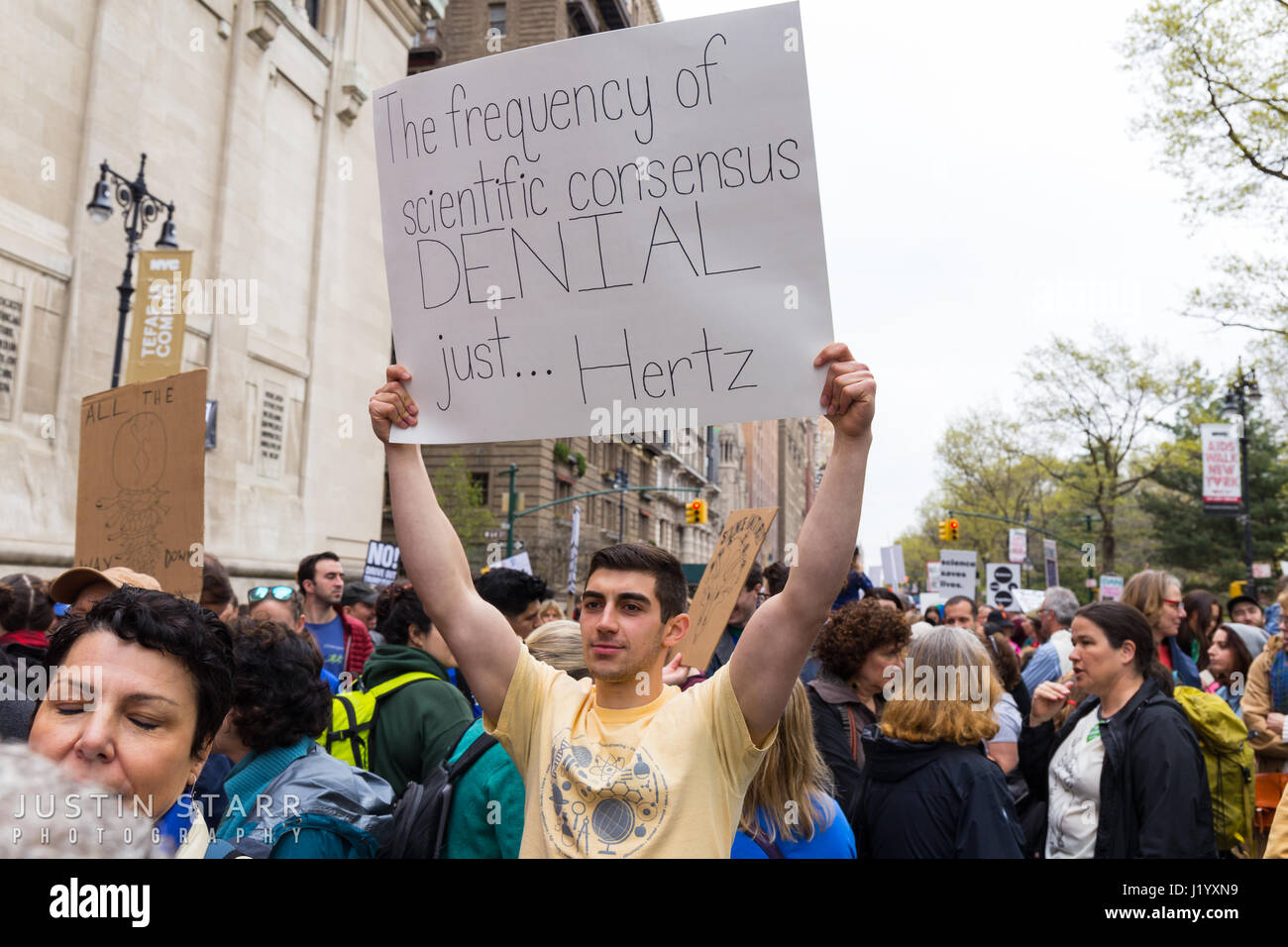 New York, USA. 22nd April, 2017. An unidentified man holds a sign that reads 'The frequency of scientific DENIAL just... Hertz' during the March For Science on April 22, 2017 in New York. Credit: Justin Starr/Alamy Live News Stock Photo