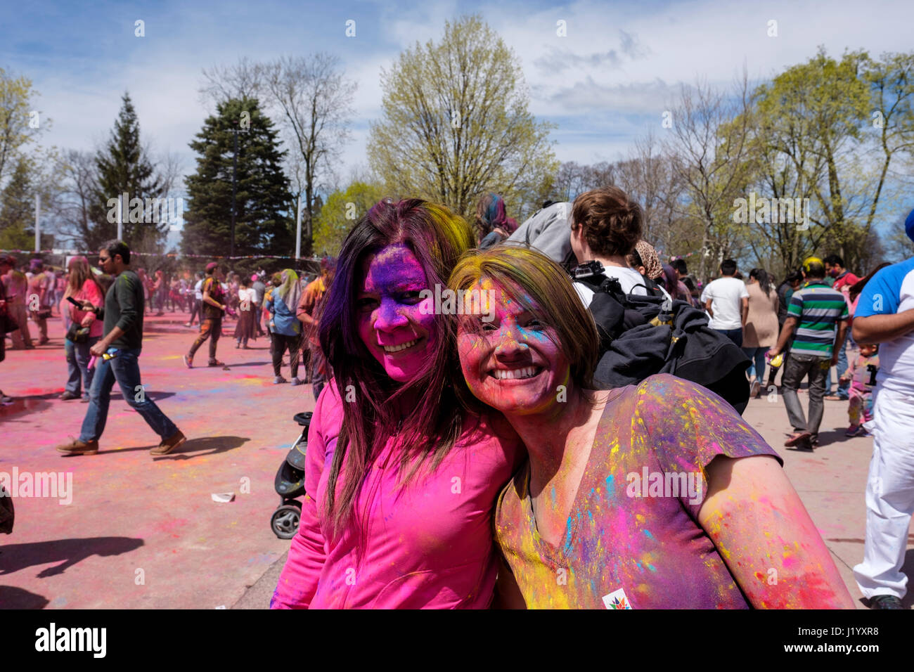 London, Ontario, Canada, 22nd Apr, 2017. Two teen girls with face paing smiling at the camera at Victoria Park during the Holi Spring Festival, also known as Rangwali Holi, Dhuleti, Dhulandi, Phagwah, or simply as Festival of Colours, an Hindu festival to celebrate the arrival of Spring in London, Ontario, Canada. Credit: Rubens Alarcon/Alamy Live News. Stock Photo