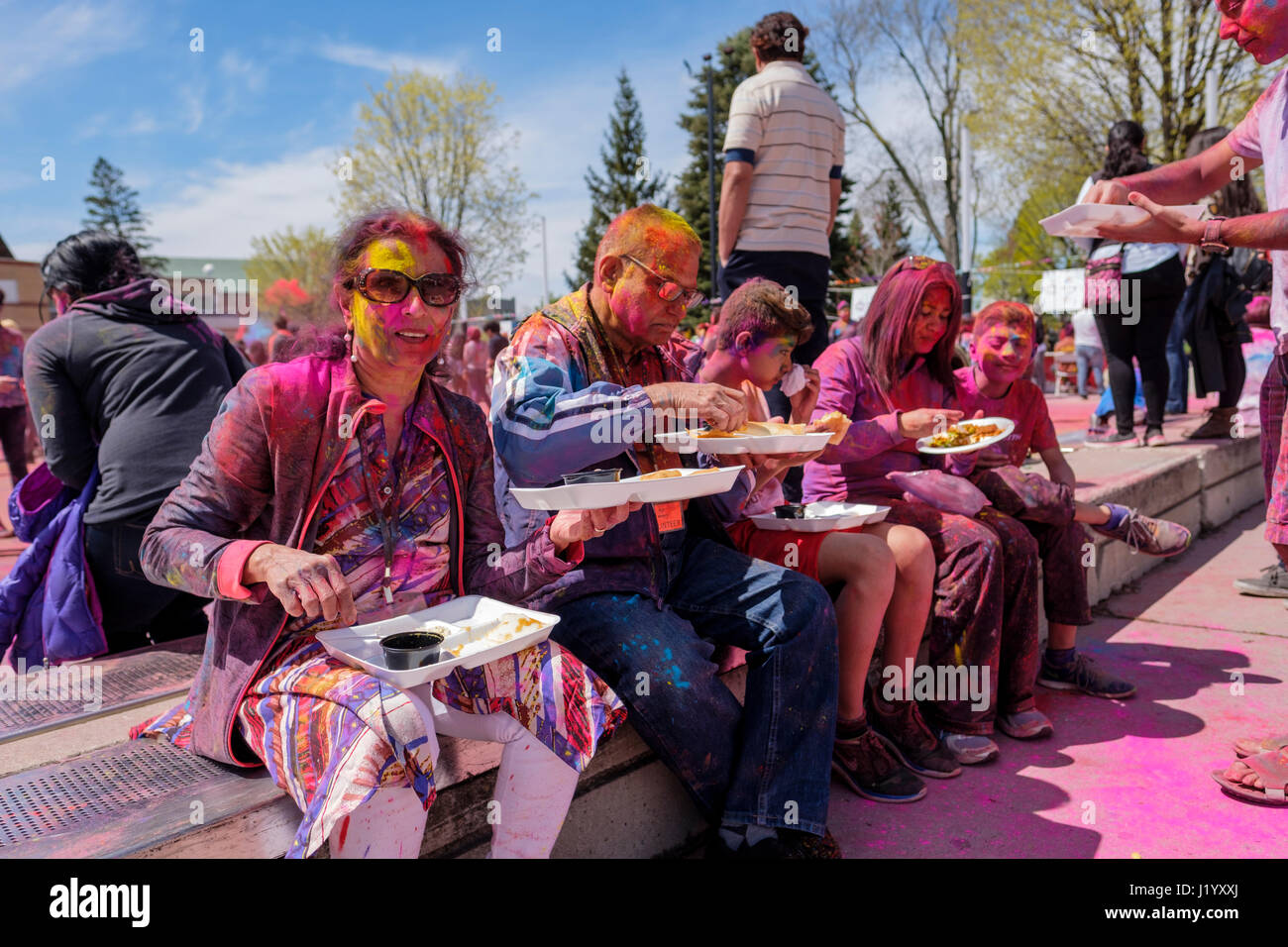 London, Ontario, Canada, 22nd Apr, 2017. A family take a break for eating at Victoria Park during the Holi Spring Festival, also known as Rangwali Holi, Dhuleti, Dhulandi, Phagwah, or simply as Festival of Colours, an Hindu festival to celebrate the arrival of Spring in London, Ontario, Canada. Credit: Rubens Alarcon/Alamy Live News. Stock Photo