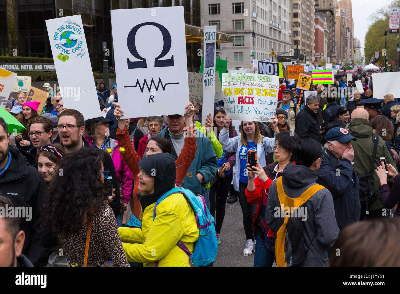 New York, USA. 22nd April, 2017. With many holding signs, the procession of the March For Science passes in front of the Trump International Hotel & Tower on Central Park West on April 22, 2017 in New York. Credit: Justin Starr/Alamy Live News Stock Photo
